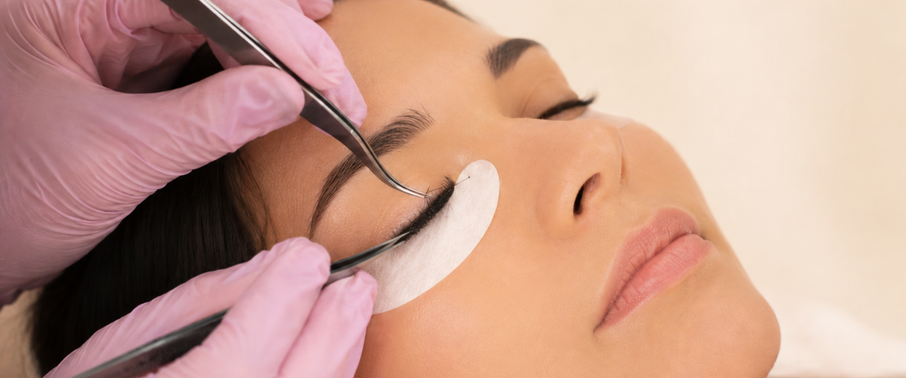 Lash professional gently isolating extensions during treatment.