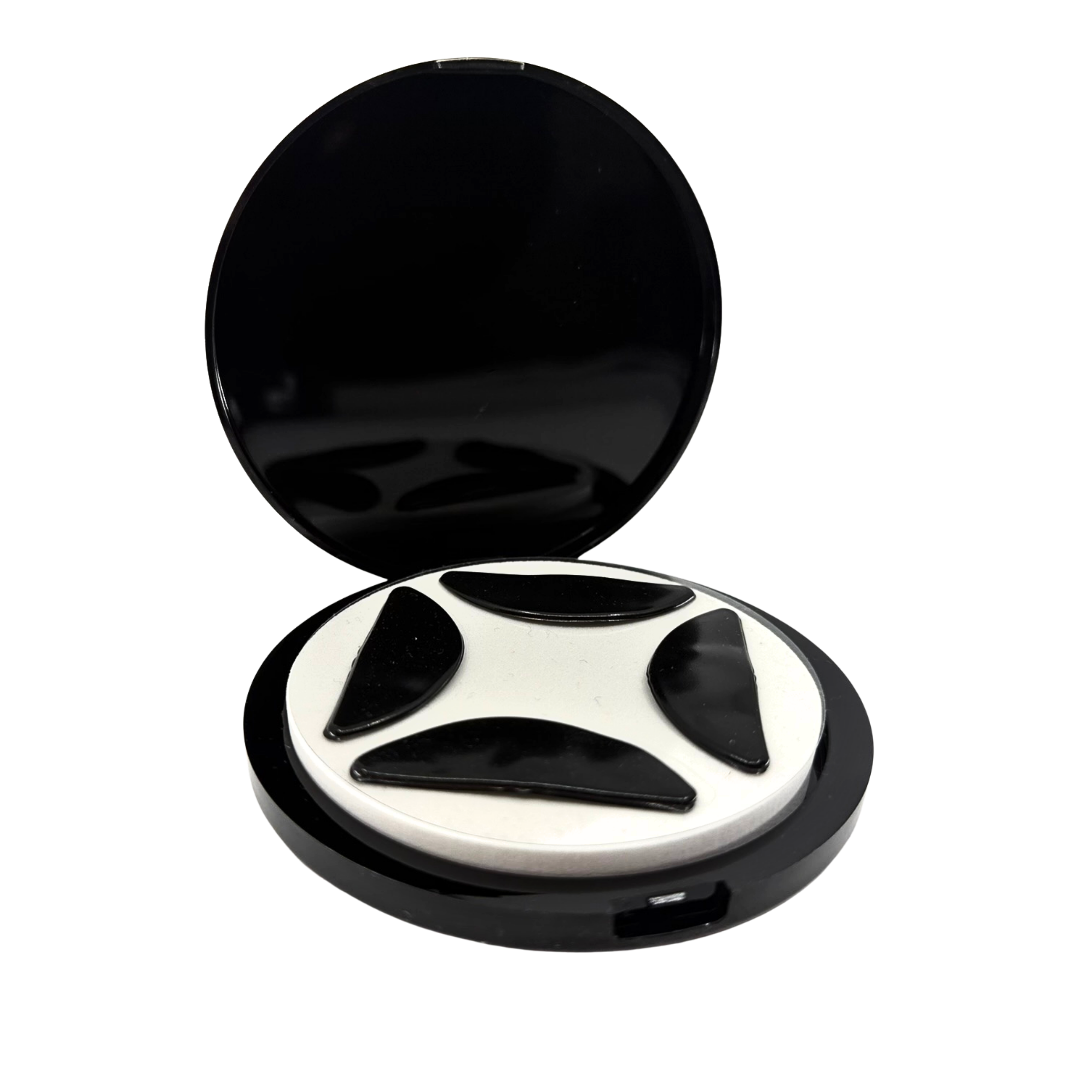 Open flutterstop case with four flutterstop pads sitting on a white foam disc