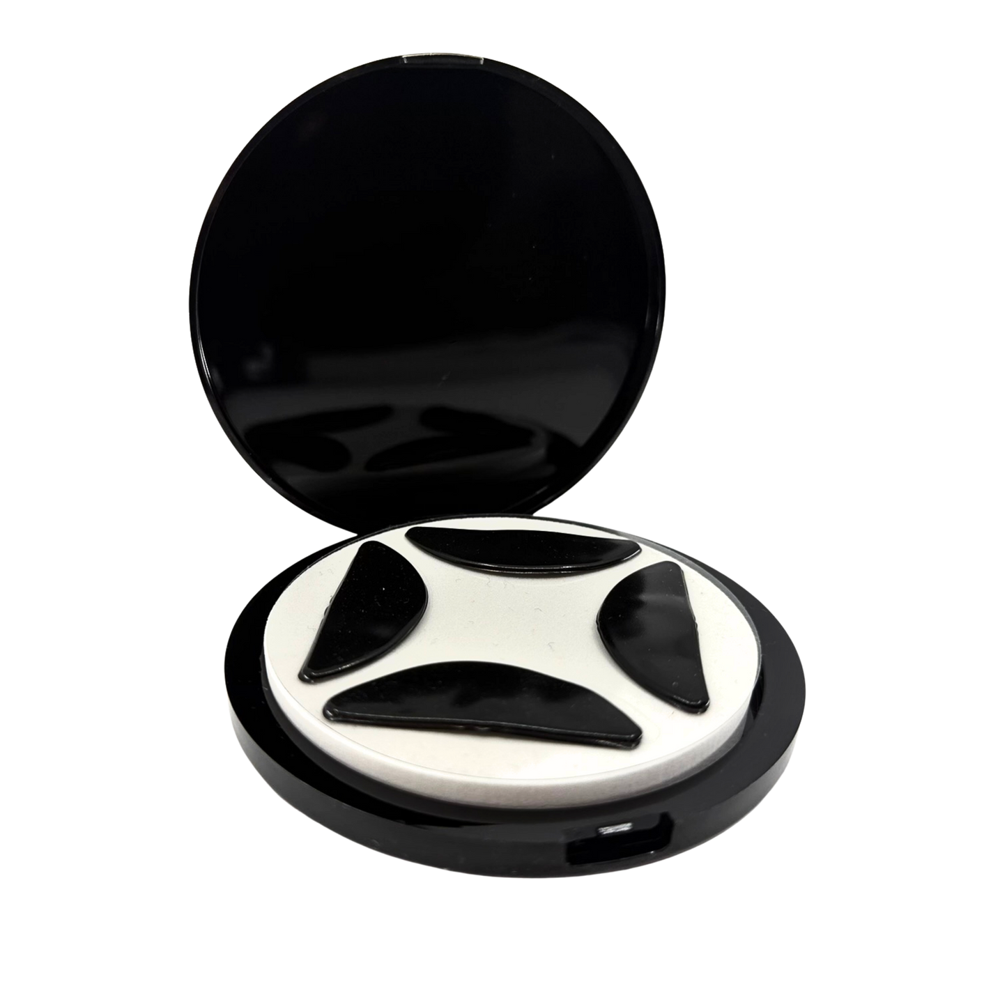 Open flutterstop case with four flutterstop pads sitting on a white foam disc
