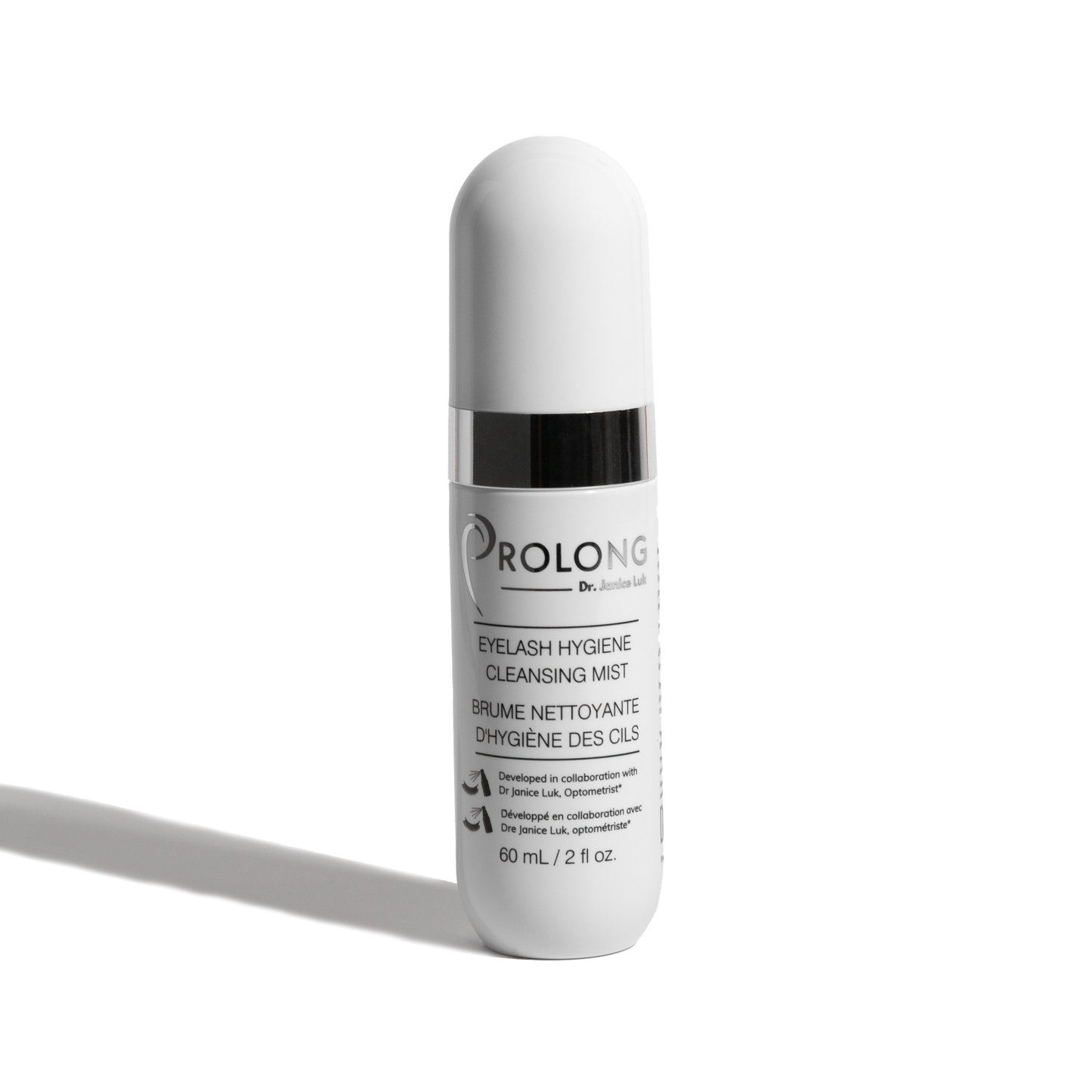 A white cylindrical cosmetic bottle with a ribbed cap and a black collar, labeled 'PROLONG DR. JANICE LUK EYELASH HYGIENE CLEANSING MIST' on a clean white background with a soft shadow.